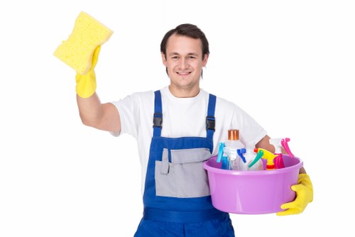 Office cleaning in a shared workspace with desks and equipment